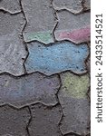 Small photo of Chalk drawings on sidewalks. A beautiful colorful geometrical ornament chalk drawing from above. Pavement painted with multicolored chalks. Top view.
