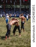 Small photo of EDIRNE, TURKEY - JULY 14, 2018 : Middle weight wrestlers battle for victory at the Kirkpinar Turkish Oil Wrestling Festival in Turkey. (wrestler turkish mean is pehlivan or guresci)
