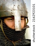 Small photo of Knight Face, close up of a young knight guard warrior viking before a battle, symbol of virtue and chivalry