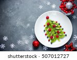 Funny edible Christmas tree, Christmas breakfast idea for kids. Beautiful Christmas and New Year food background top view blank space for text