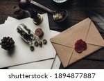 Small photo of Letter seal with wax seal stamp on the wood table. Vintage notary stamp and sealed envelope. Post concept. Sealing wax. Wax seal. Dark academia style. Scandinavian hygge styled composition.