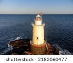 Early morning aerial image of the Sakonnet Point Light (West Island Light) between Little Compton and Tiverton Rhode Island, at Sakonnet River and Atlantic Ocean. 