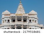 Small photo of "Prem Mandir" means temple of Love. Mathura Vrindavan temple, prem mandir with blue sky in the background , beautiful architecture. Radha Krishna temple.
