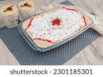 Small photo of Delicious trifle or tipsy pudding in glass tray or plate topped with cherry.