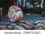 Small photo of London, UK. July 10,2023. The half human sculpture depict human body parts extending from the shells of snail and molluscs. Earthling artworks by Jocelyn McGregor’s In London at Aldgate square