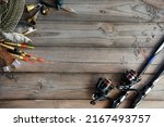 Fishing tackle background. Lifestyle. Spinning, hooks. Accessories for fishing on the wooden background. . Active hobby recreation concept. Top view, flat lay.
