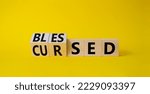 Small photo of Blessed vs Cursed word symbol. Turned wooden cubes with words Cursed and Blessed. Beautiful yellow background. Religious and Blessed vs Cursed concept