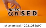 Small photo of Blessed vs Cursed word symbol. Businessman Hand turns cubes with word Cursed and changes it to word Blessed. Beautiful orange background. Religious and Blessed vs Cursed concept