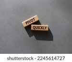 Small photo of Pivot quickly symbol. Wooden blocks with words Pivot quickly. Beautiful grey background. Business and Pivot quickly concept. Copy space.