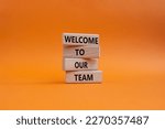 Welcome to our team symbol. Concept words Welcome to our team on wooden blocks. Beautiful orange background. Business and Welcome to our team concept. Copy space.