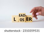 Small photo of Leader vs Loser symbol. Businessman hand points at wooden cubes with words Loser and Leader. Beautiful white background. Leader vs Loser and business concept. Copy space