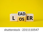Small photo of Leader vs Loser symbol. Wooden cubes with words Loser and Leader. Beautiful yellow background. Leader vs Loser and business concept. Copy space