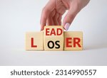 Small photo of Leader vs Loser symbol. Businessman hand turns wooden cubes and changes the word Loser to Leader. Beautiful white background. Leader vs Loser and business concept. Copy space
