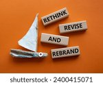 Small photo of Rethink Revise and Rebrand symbol. Wooden blocks with words Rethink Revise and Rebrand. Beautiful orange background with boat. Business and Rethink Revise and Rebrand concept. Copy space.
