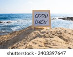 Small photo of Good luck symbol. Good luck white chalk blackboard. Beautiful sea background. Business and Good luck concept. Copy space.