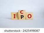 Small photo of ICO and IPO symbol. Wooden cubes with words ICO - initial coin offering and IPO - initial public offering. Beautiful white background. Business concept. Copy space