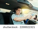 Small photo of View of a driver asleep at the wheel. Tired driver with closed eyes at the wheel, concept of man asleep while driving. A drowsy driver at the wheel, a tired person while driving