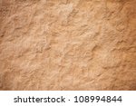 Details of sand stone texture, closeup shot of rock surface with vignette at cover and bright spot at centre, idea for background or backdrop.