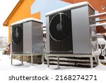 Small photo of Two residential modern heat pumps buried in snow