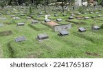 Small photo of The public cemetery complex (TPU) at Karet Bivouac, people making pilgrimages, funeral officials, people sowing flowers. Jakarta-Indonesia-December 2022.