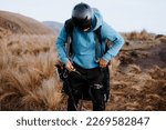 Small photo of Man makes sure to jump on the paraglider. A man secures his equipment to fly