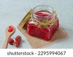 Small photo of Jar of raspberry jam on marble background from top view, Fresh homemade raspberry jam in glass, Sweet homemade raspberry jam in small glass jar on wooden background, with fresh berries copy space.