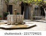 fountain inside old stone house surrounded by greenery, central courtyard, mexico latin america