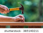 Using hammer and nail on wood...