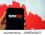 Small photo of PENANG, MALAYSIA - FEB 2, 2021: GameStop Corp sign is seen on a smartphone. GameStop's stock plunged more than 30% after Robinhood and other trading platforms limited investors' ability to the shares.