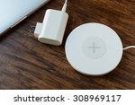 modern wireless charger left of a wooden table