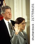 Small photo of Washington DC, USA -AUGUST 10, 1993 Ruth Bader Ginsburg is Sworn in as Associate Justice of the Supreme Court of the United States. President William Clinton stands behind her