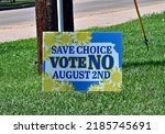 Small photo of EMPORIA, KANSAS, USA - AUGUST 2, 2022 Political campaign signs for and against the Kansas House Concurrent Resolution 5003 (Value Them Both constitutional amendment) vote in today’s primary election.