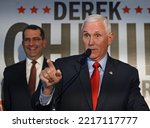 Small photo of WICHITA, KANSAS, USA - OCTOBER 21, 2022 Former United Sates Vice President Mike Pence (R) addresses a crowd of GOP supporters during a rally for Kansas Attorney General Derek Schmidt for governor