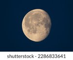 Small photo of The waning gibbous moon hangs high in the sky, its golden glow casting a serene and peaceful aura over the world below. As the moon slowly makes its way towards its next phase.