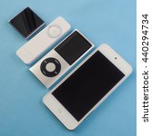 Small photo of BERRY, AUSTRALIA - June 20 2016 : A group of Apple iPods - iPod Nano 6th generation, iPod Shuffle 1st generation, iPod Touch 5th generation and iPod Nano 4th generation - on a plain blue background.
