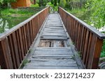 A broken wooden bridge is unsuitable for crossing the river