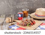 Small photo of Fiestas Patrias Chile September 18, Independence Day. Anticuchos, mote con huesillo, chicha or wine, Sombrero huaso chupallas de paja and emboque, on a wooden table with a flag. copy space