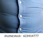 man with overweight. symbolic photo for beer belly, unsuccessful dieting and eating the wrong foods. Weight loss concept. Tight shirt.