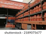 Small photo of Al Ahsa Saudi Arabia August 2022 : Gas cylinders lorry truck unloaded in the storage of LPG shop in Arabic translated Abul Latif Naaser.