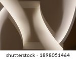 Small photo of Close-up photo of glowing ceiling structure. Abstract architecture fragment. Modern interior design with curved elements. Geometric composition of curves and surfaces in gray halftones.