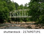 Small photo of Rustic bridge overtop of creek