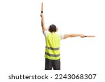 Rear view shot of an aircraft marshaller signalling with wands isolated on white background