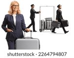 Small photo of Businesswoman with a suitcase and bellboys pushing a luggage cart isolated on white background
