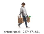 Small photo of Full length shot of a young african american man carrying grocery bags walking and looking back isolated on white background