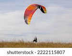Small photo of Ferryland, Newfoundland and Labrador, Canada - October 15, 2022: A paraglider taking advantage of the steady ocean winds moving upslope on the outskirts of the coastal town of Ferryland.