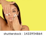 Beautiful model girl, woman with a white manicure nail design isolated on yellow background. Fashion natural makeup and care for hands and nails and cosmetics.
