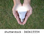 LED Bulb with lighting on hand with nature background