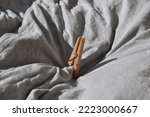 Wooden clothes peg on fabric background.