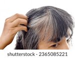 Small photo of Asian lady with gray hair. Older woman with grey hair problem. Girl being stressed with damaged silver gray hair appearing on her head.