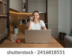 Small photo of Simple living. Young freelance business woman working at home on laptop as product strategy expert. Female expatriate remote work on internet on computer online for foreign company as web developer.